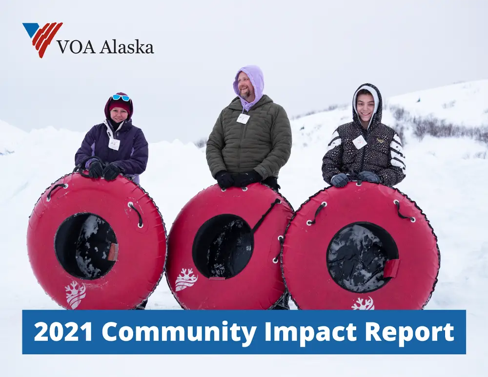 Cover of 2021 Impact report with three people standing in snow with innertubes