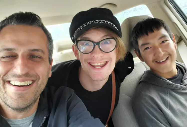 Three people in car smiling for a selfie