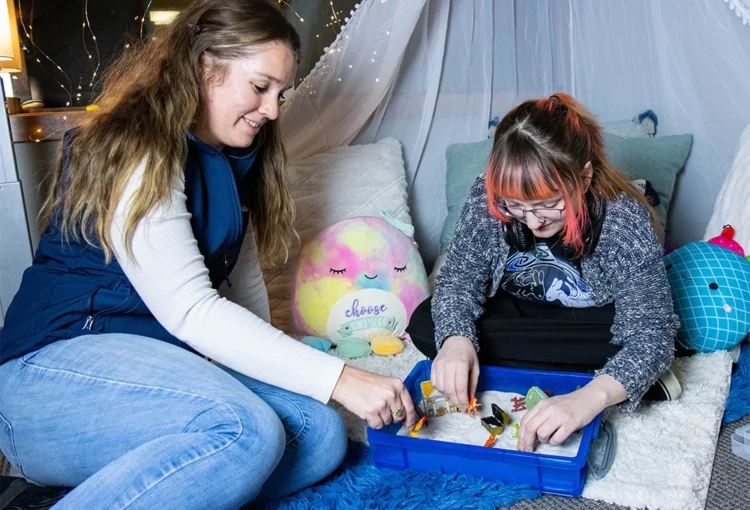Therapist and a youth using a sand tray during a session