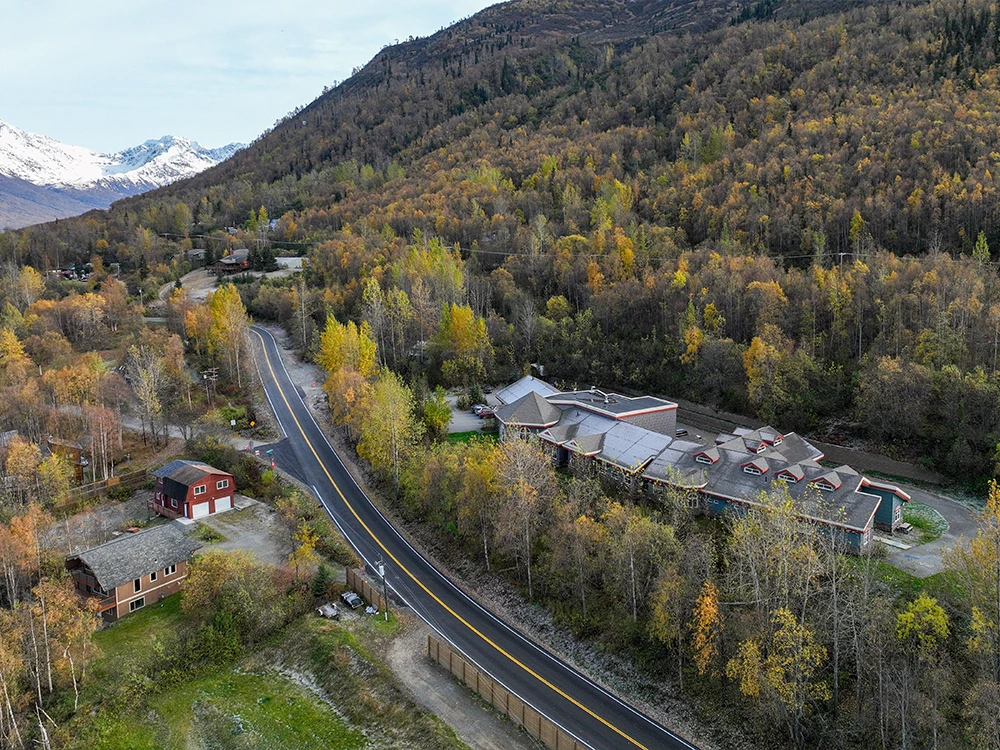 Aerial image of ARCH in the mountains, surrounded by fall foliage