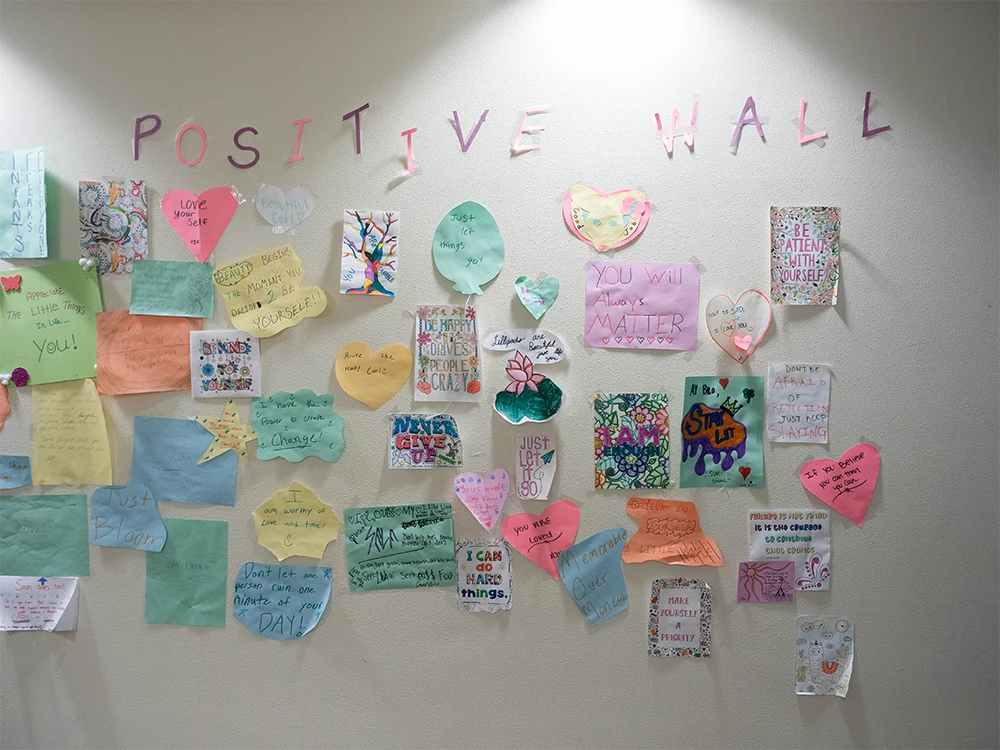 A large colorful collection of positive messages on a wall.